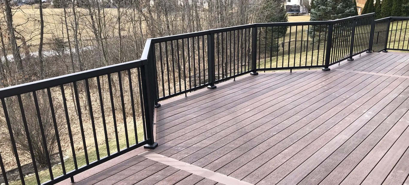 Beautiful wood deck with black metal railings overlooking backyard in Pittsburg, CA