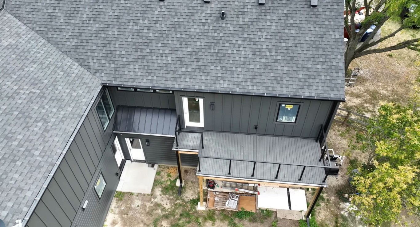 Aerial view of house with charcoal composite deck and white railings
